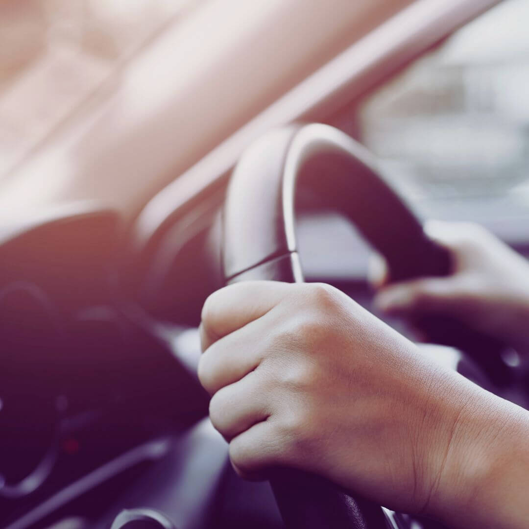 A Pair Of Hands on The Steering Wheel of A Car